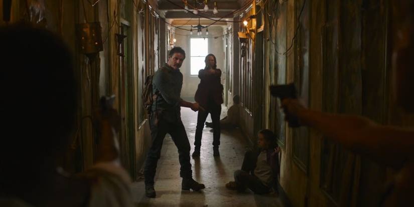 Joel, Tess, and Ellie in a hallway in The Last of Us.