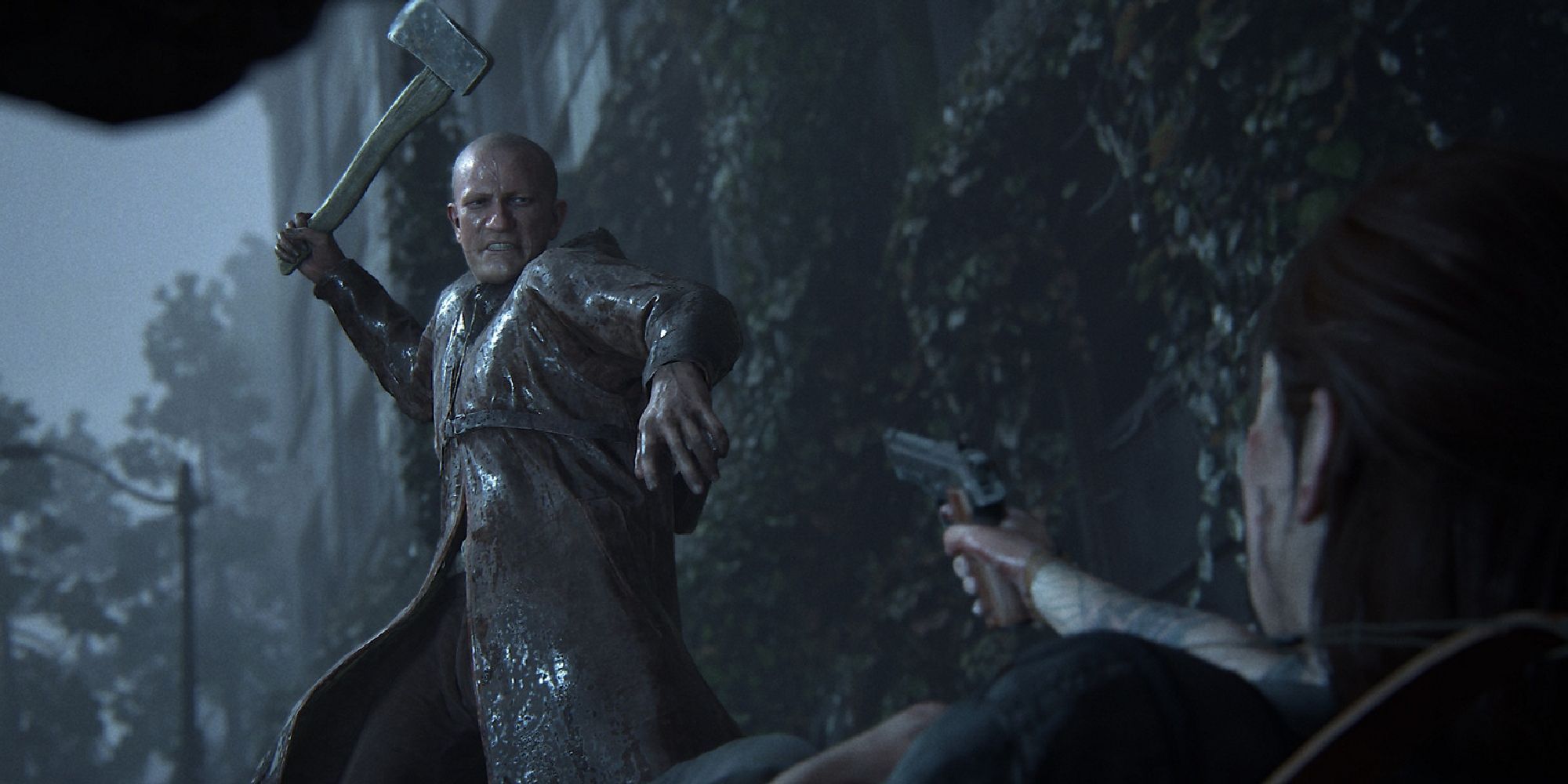 Man With An Axe Preparing To Attack Ellie As She Is Pinned To The Ground While Pointing A Gun At Him In The Last Of Us 2