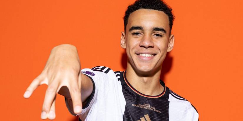 Musiala posing while wearing a Germany jersey