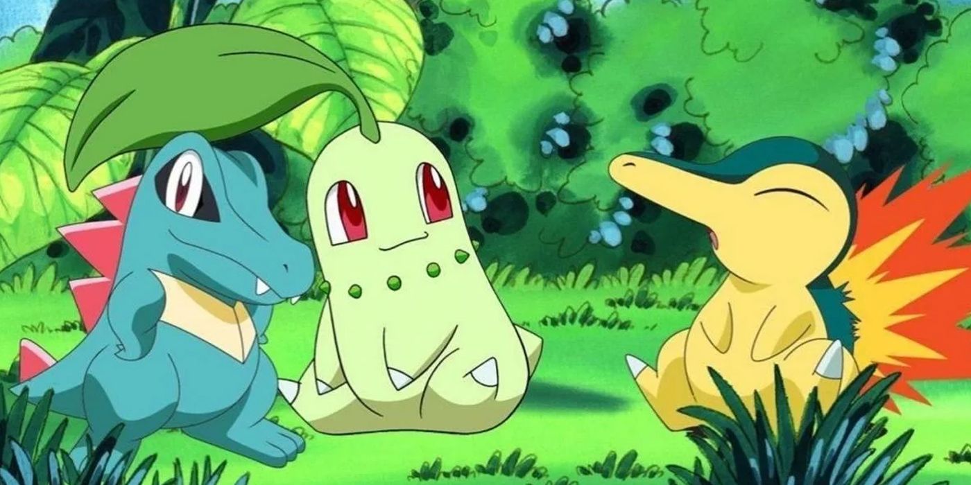 Johto starter Pokemon Totodile, Chikorita, and Cyndaquil sit together in the grass.