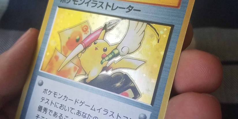 A photo of someone holding the Illustrator Pikachu Pokemon card.