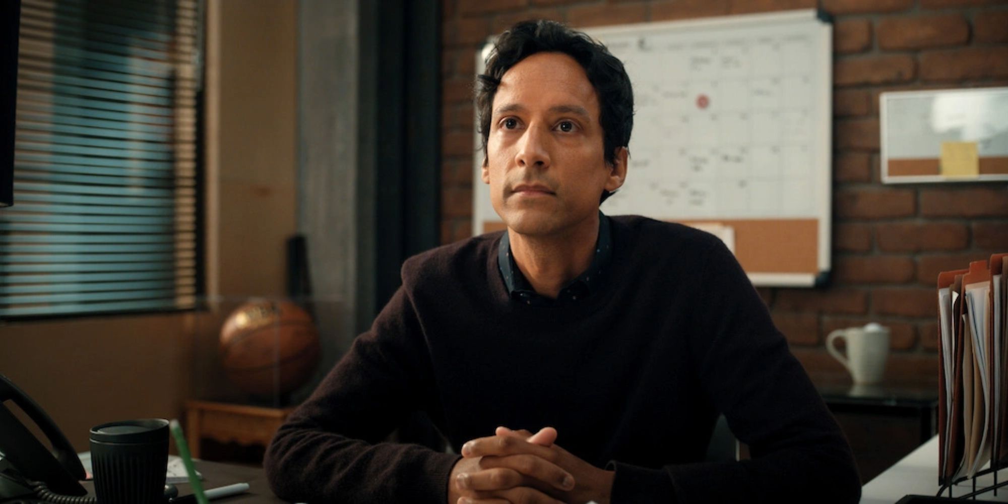 Danny Pudi at a desk in Mythic Quest