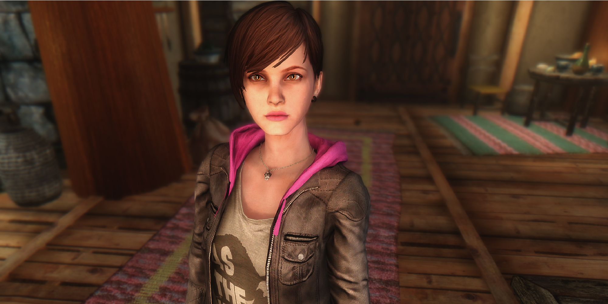 Moira stands in a neutral pose in a well-lit room, facing the camera with a neutral expression.