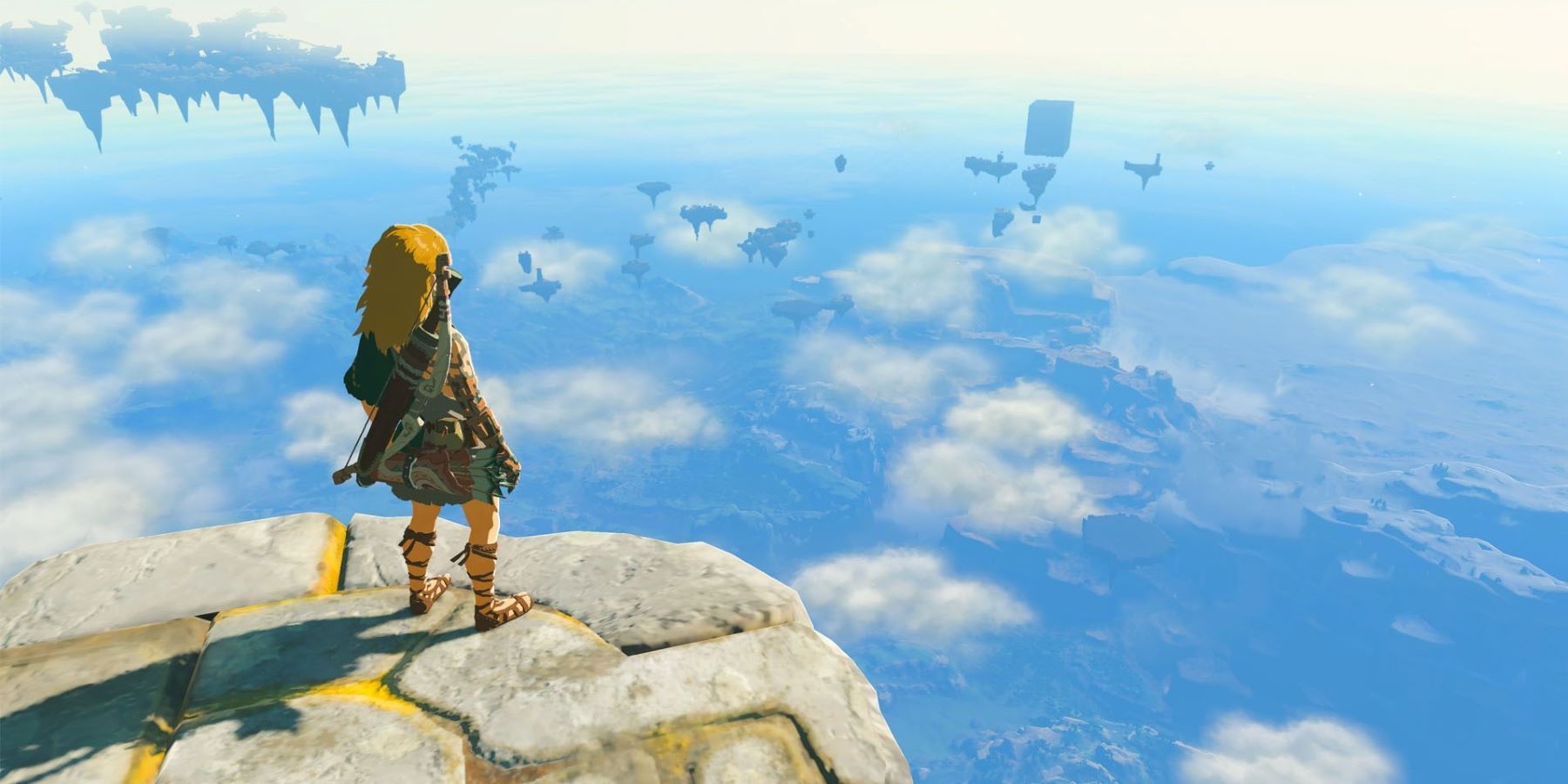 Link standing on a platform looking at distant sky islands in The Legend of Zelda: Tears of the Kingdom