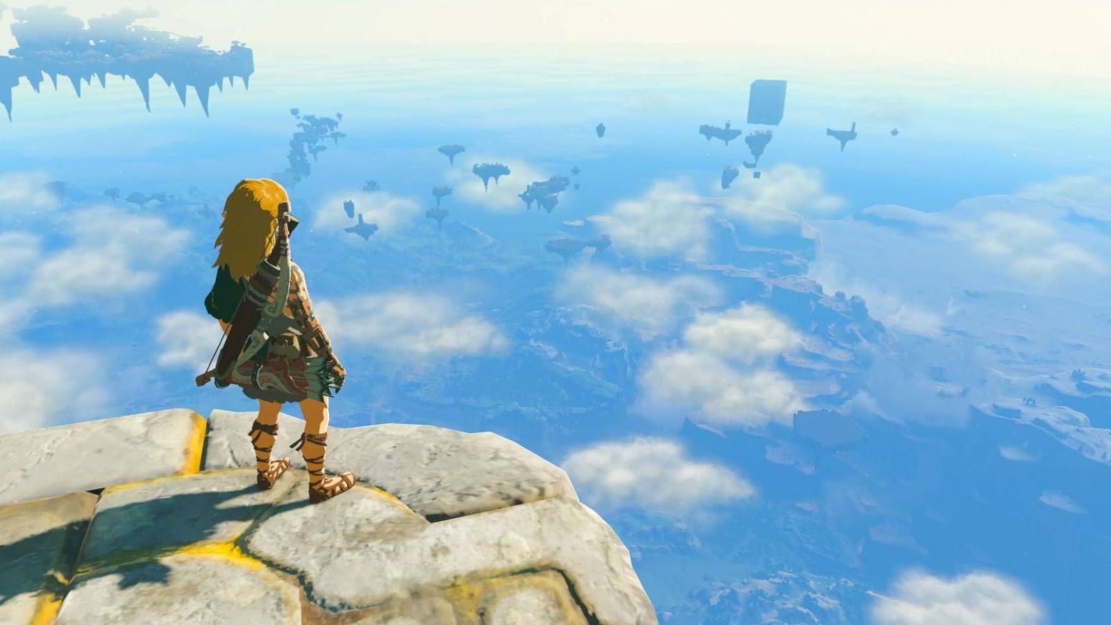 Link standing on a platform looking at distant sky islands in The Legend of Zelda: Tears of the Kingdom
