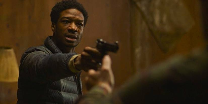 Henry pointing a gun in The Last of Us.