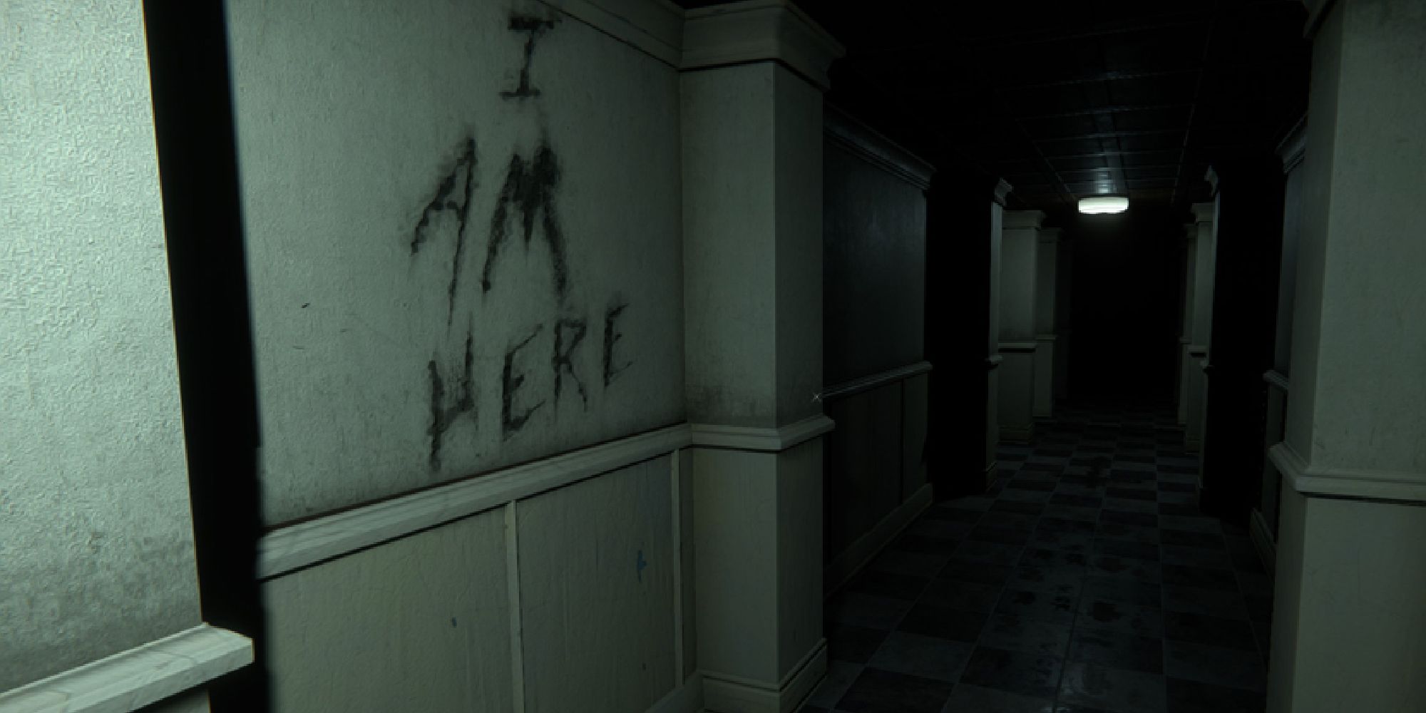 One of the dark and eerie corridors of the morgue, with the words 'I am here' written on the wall.