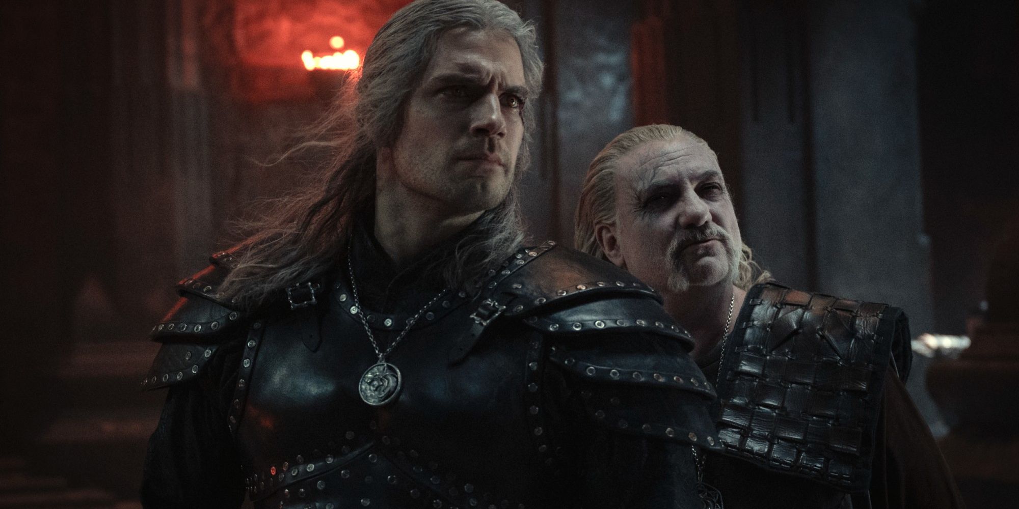 Geralt and Vesemir standing together with looks of determination. 