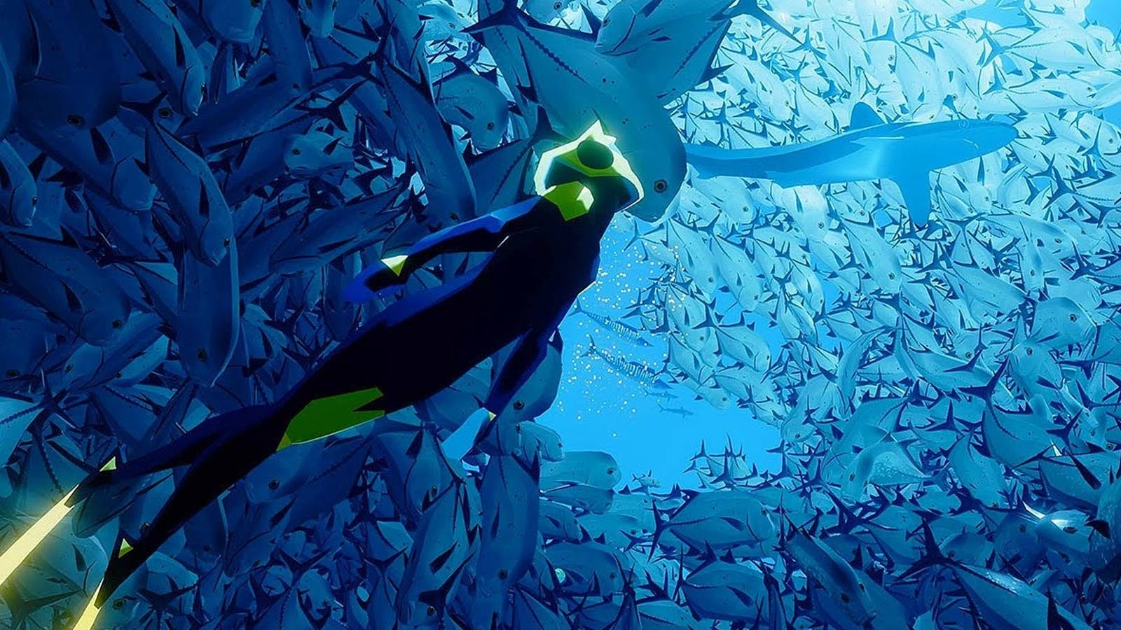 Screenshot of diver in Abzu swimming up toward a shoal of fish, a great white towards the top.
