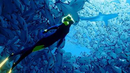 A screenshot of a diver in Abzu swimming towards a school of fish, with a large white pointing upwards.
