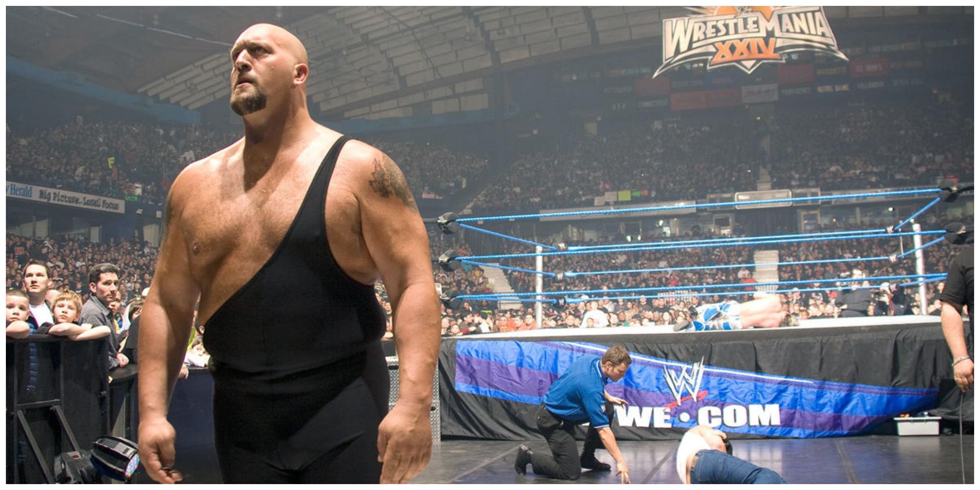 Big Show walking away from the WWE ring with another wrestler lying in the background.