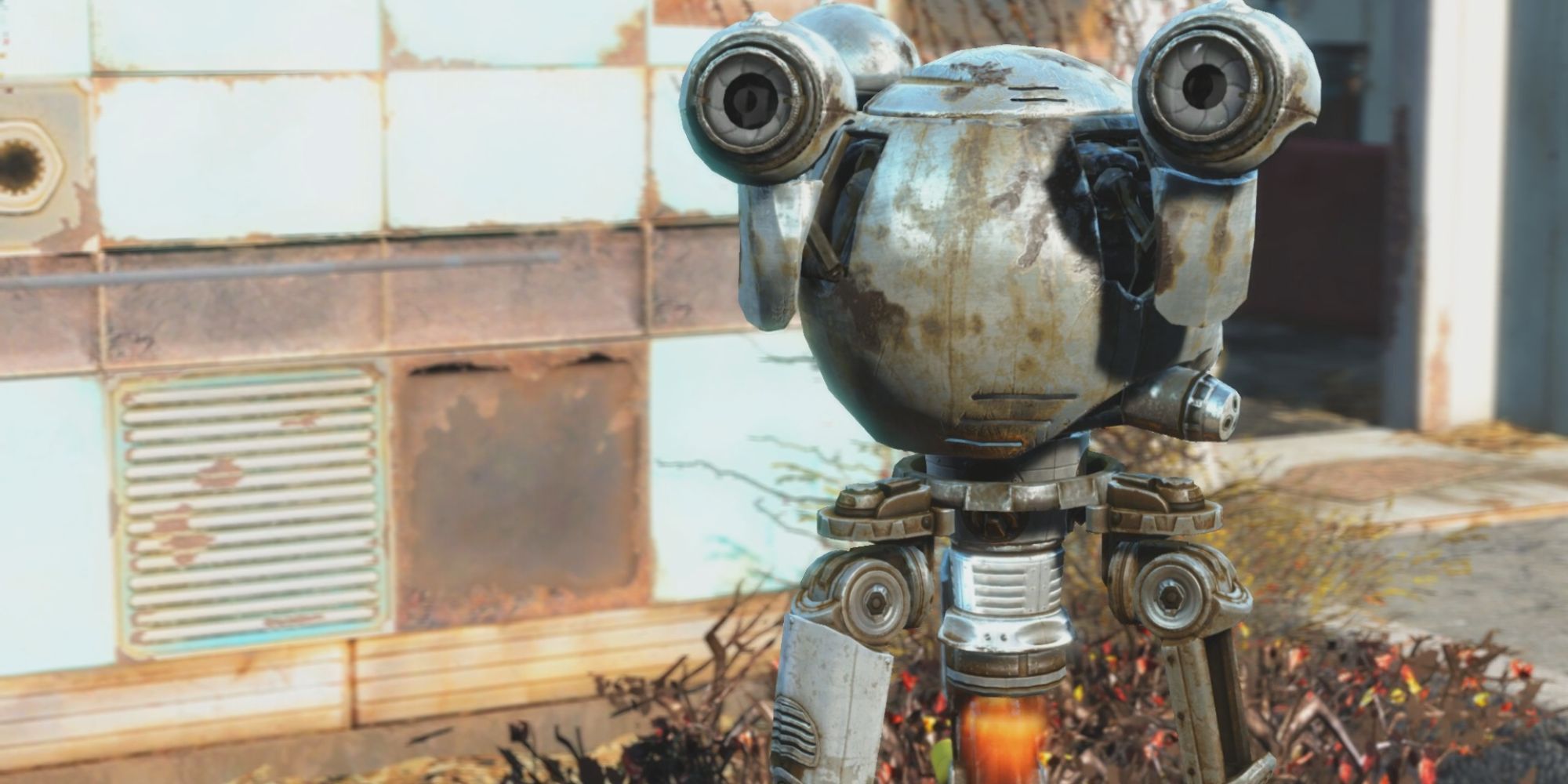 Fallout's Codsworth droid is dirty and rusty. In the background is a paneled wall that is rusted and some dead shrubbery