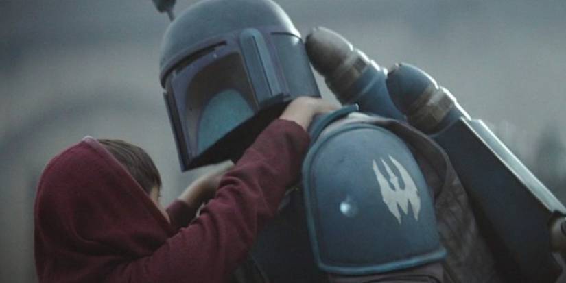 a death watch mandalorian rescuing young din djarin
