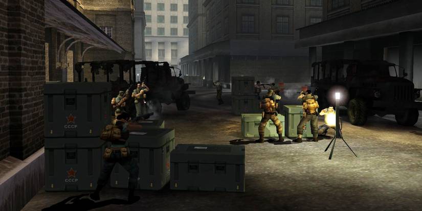 A few people shielding themselves behind containers armed in Freedom Fighters