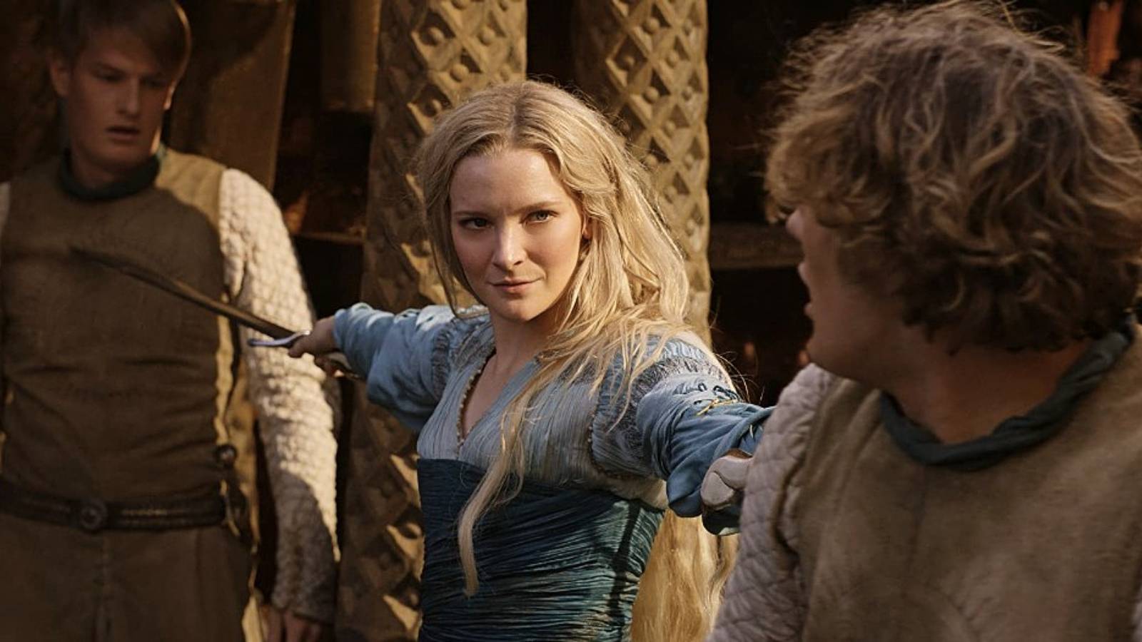 Lord of the Rings: The Rings of Power Morfydd Clark holding person at swordpoint