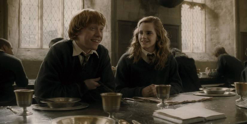 Ron and Hermione sitting in the dining hall at Hogwarts in Harry Potter