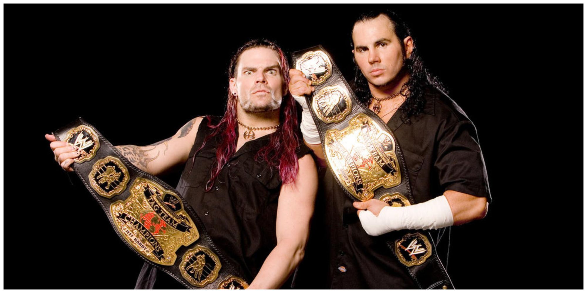 Jeff Hardy and Matt Hardy holding the WWE Tag Team Championships