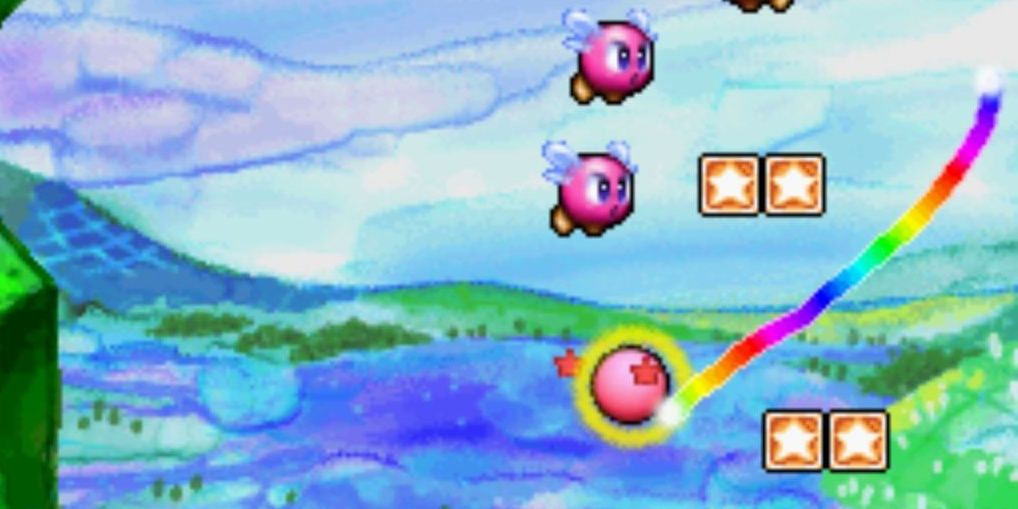 A rainbow line that the Kirby ball is following while enemies fly nearby in Kirby Canvas Curse