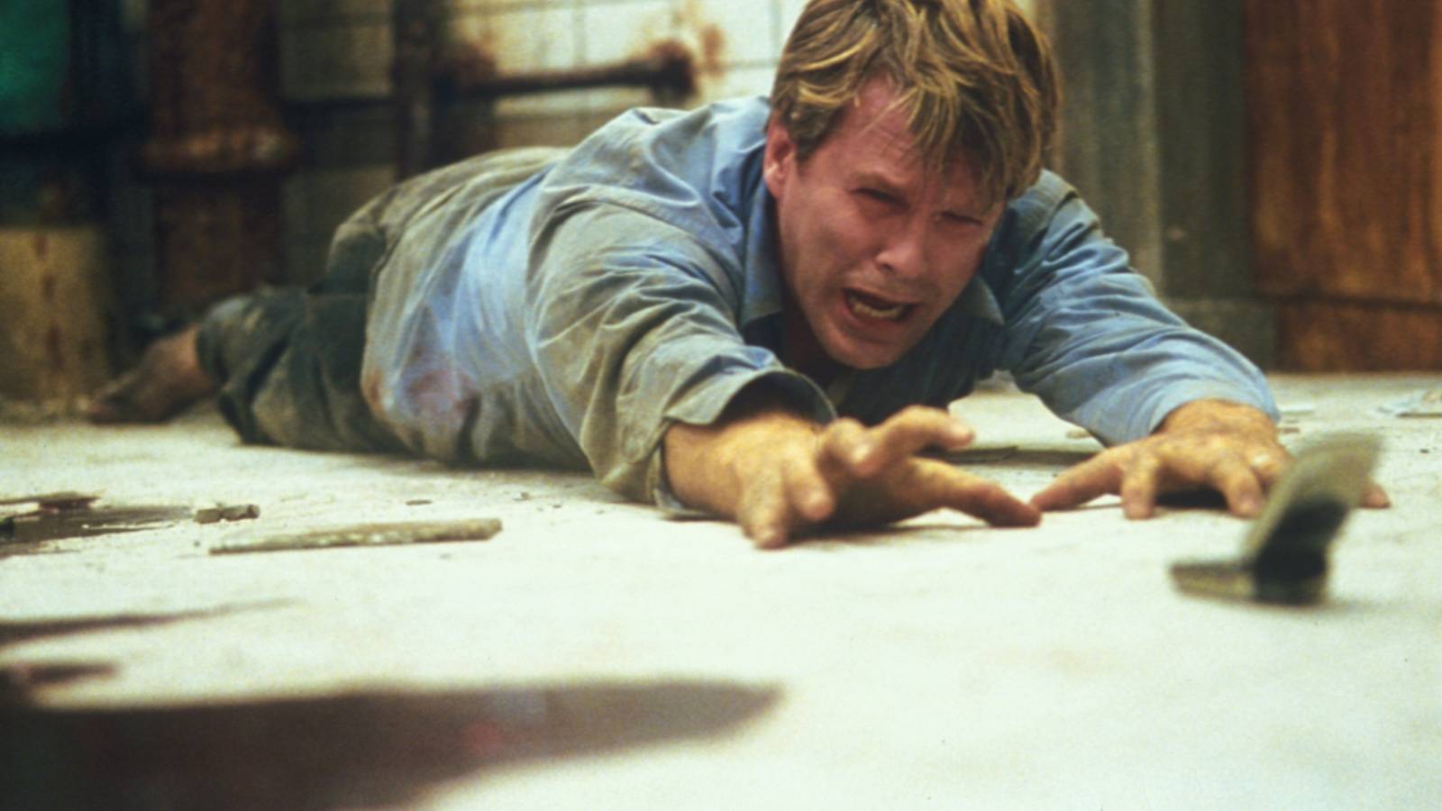 Adam lying on the floor in Saw (2004)