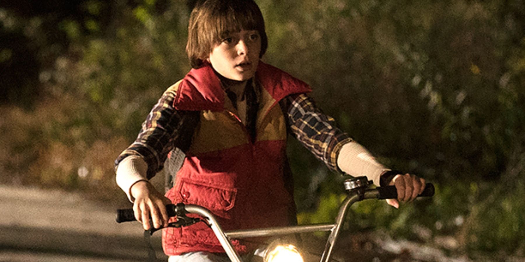 Will Byers riding his bike in season 1 of Stranger Things