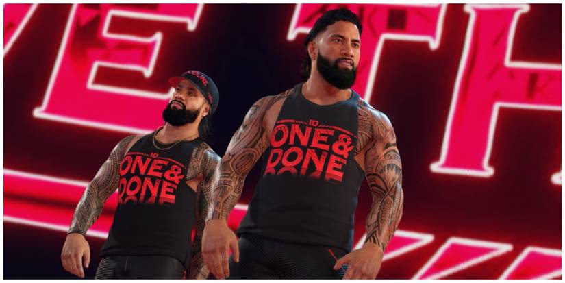 Jimmy and Jey Uso walking to the WWE. Jimmy is wearing a cap and they are both wearing matching black tank tops that have "One & Done" written on them in red.