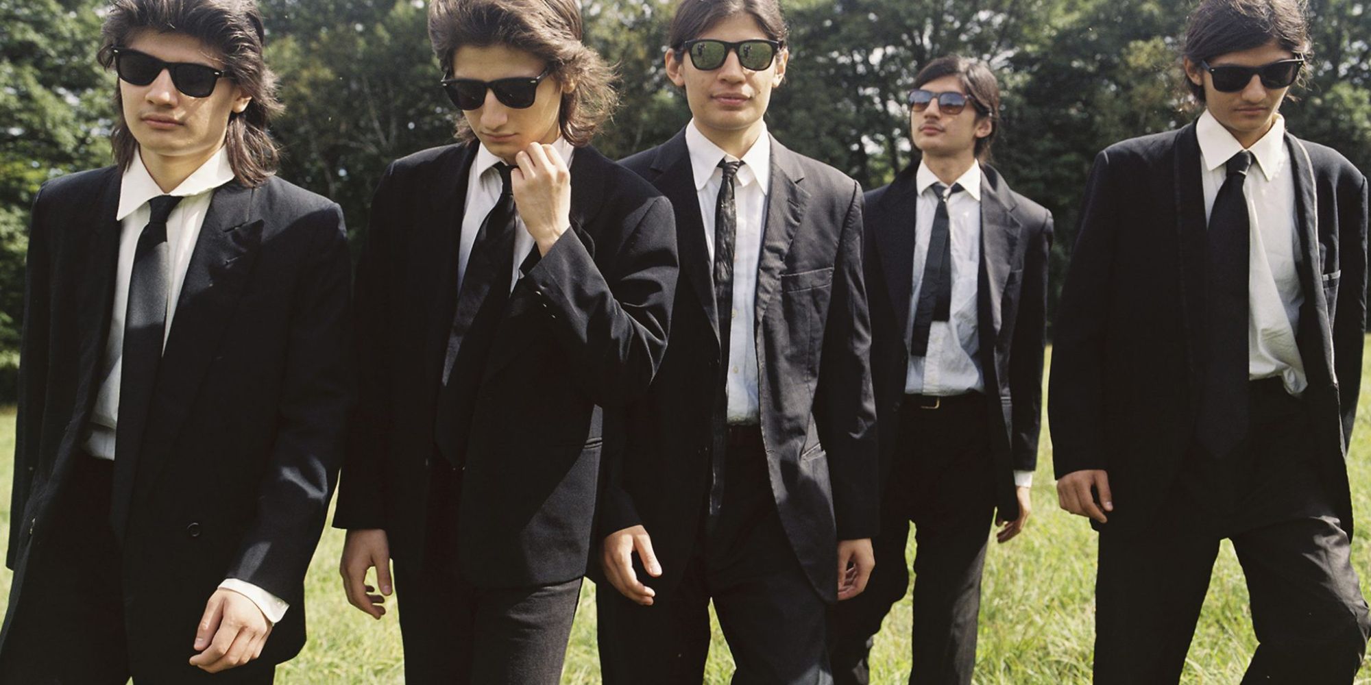 (photo) a group of five teenage boys wearing black tie suits