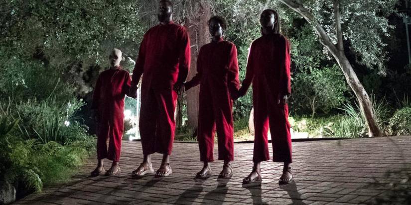 The Tethered Clones holding hands in Us