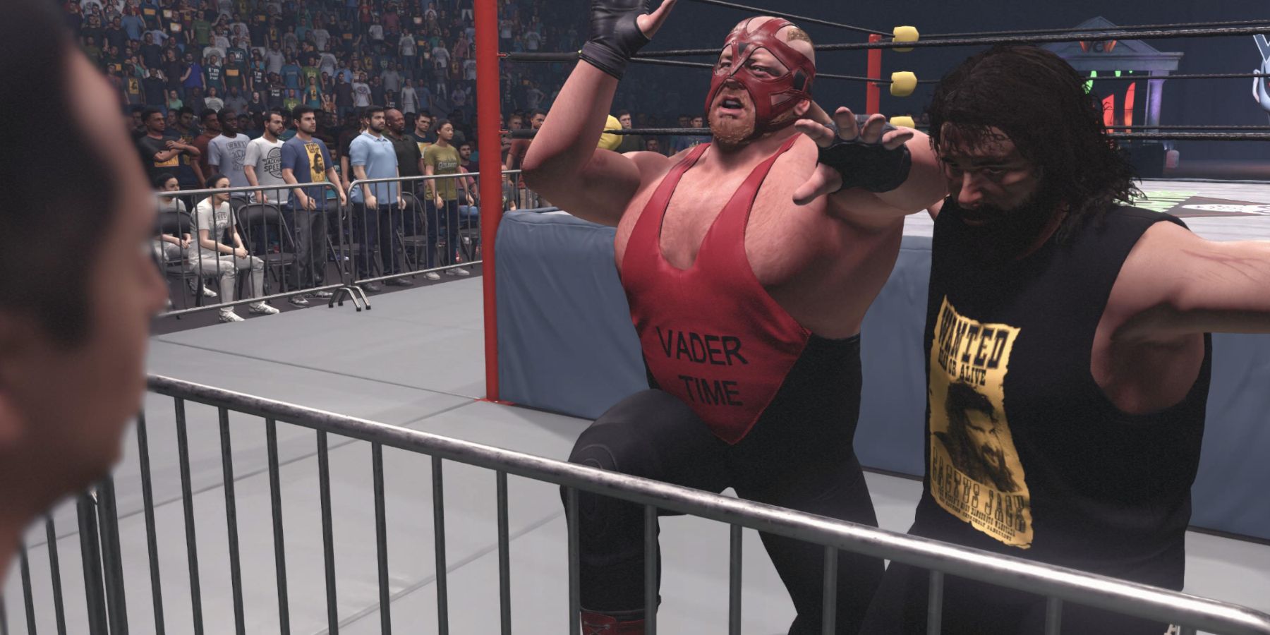 WWE 2K23 Cactus Jack uses the guardrail to attack Vader