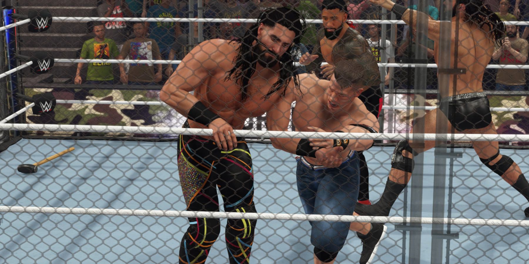 WWE 2K23 Cena throwing Rollins into the fence in the WarGames rules