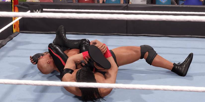 WWE 2K23 Nakamura with the arm and leg triangle on Goldberg