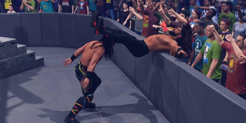 WWE 2K23 Seth Rollins Powerbombs Roman on to the barricade
