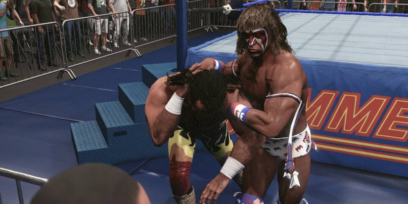 WWE 2K23 Ultimate Warrior dragging Jake Roberts outside the ring