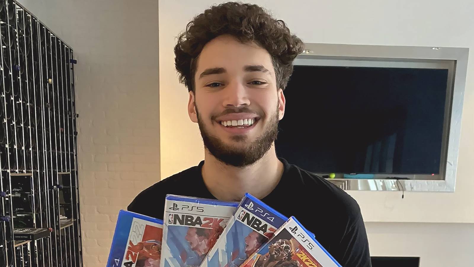 Adin Ross holding NBA 2K games for PS4 and PS5