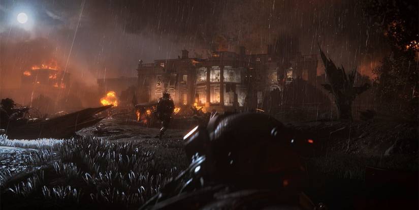 A man walking towards a burning building in Call Of Duty: Modern Warfare 2 Remastered