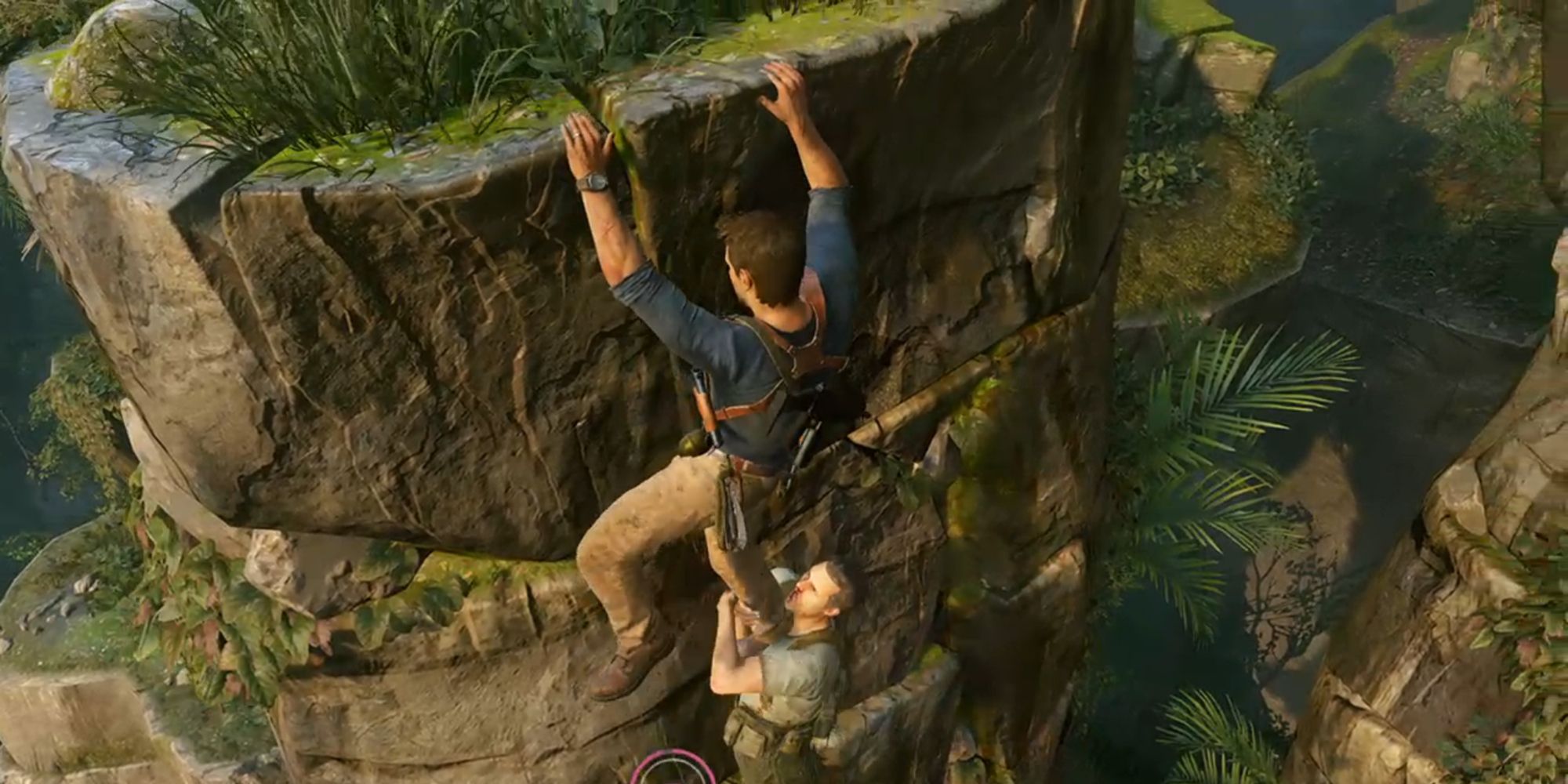 Nathan Drake hanging from a ledge with an adversary hanging onto his leg in the Uncharted game