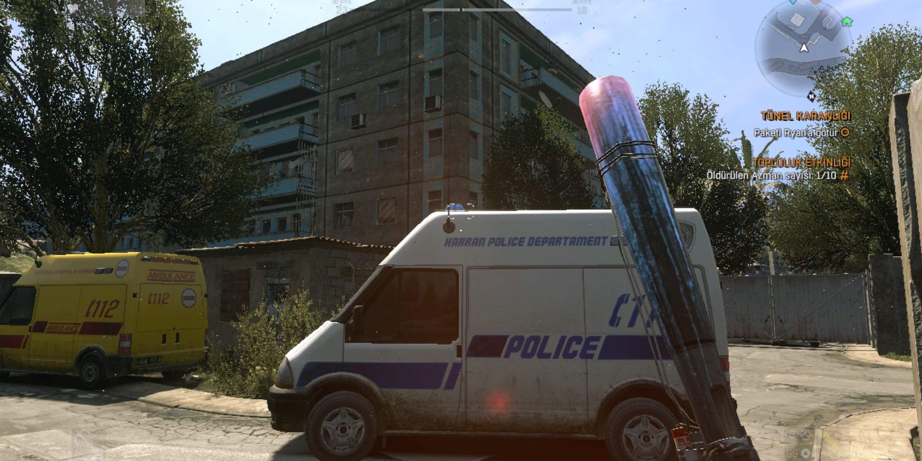 police baton and police van in dying light