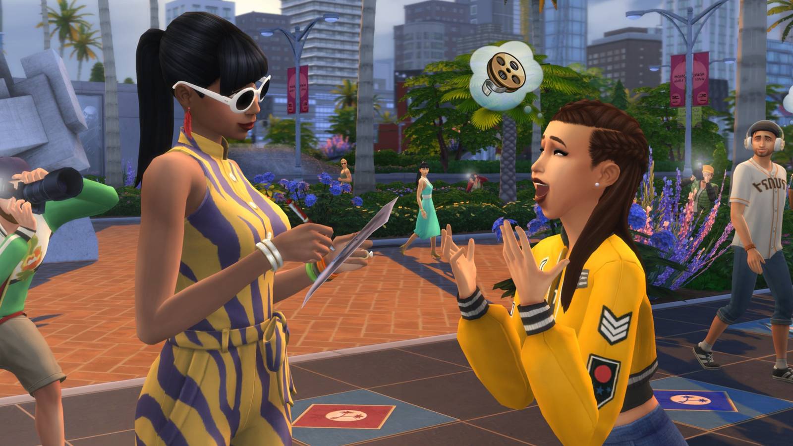 A Sim signs an autograph for their fan while paparazzi and members of the public watch on.