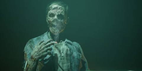 A rotting corpses puppeteered by machinery, holding a lit cigarette in The Dark Pictures Anthology