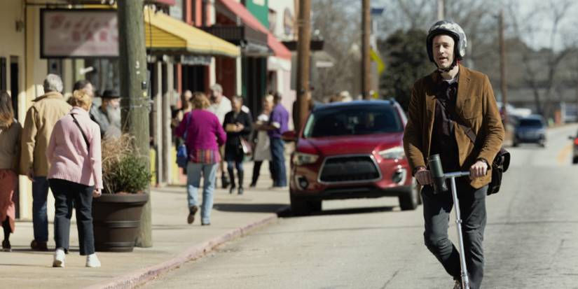 Dusty rides scooter in The Big Door Prize