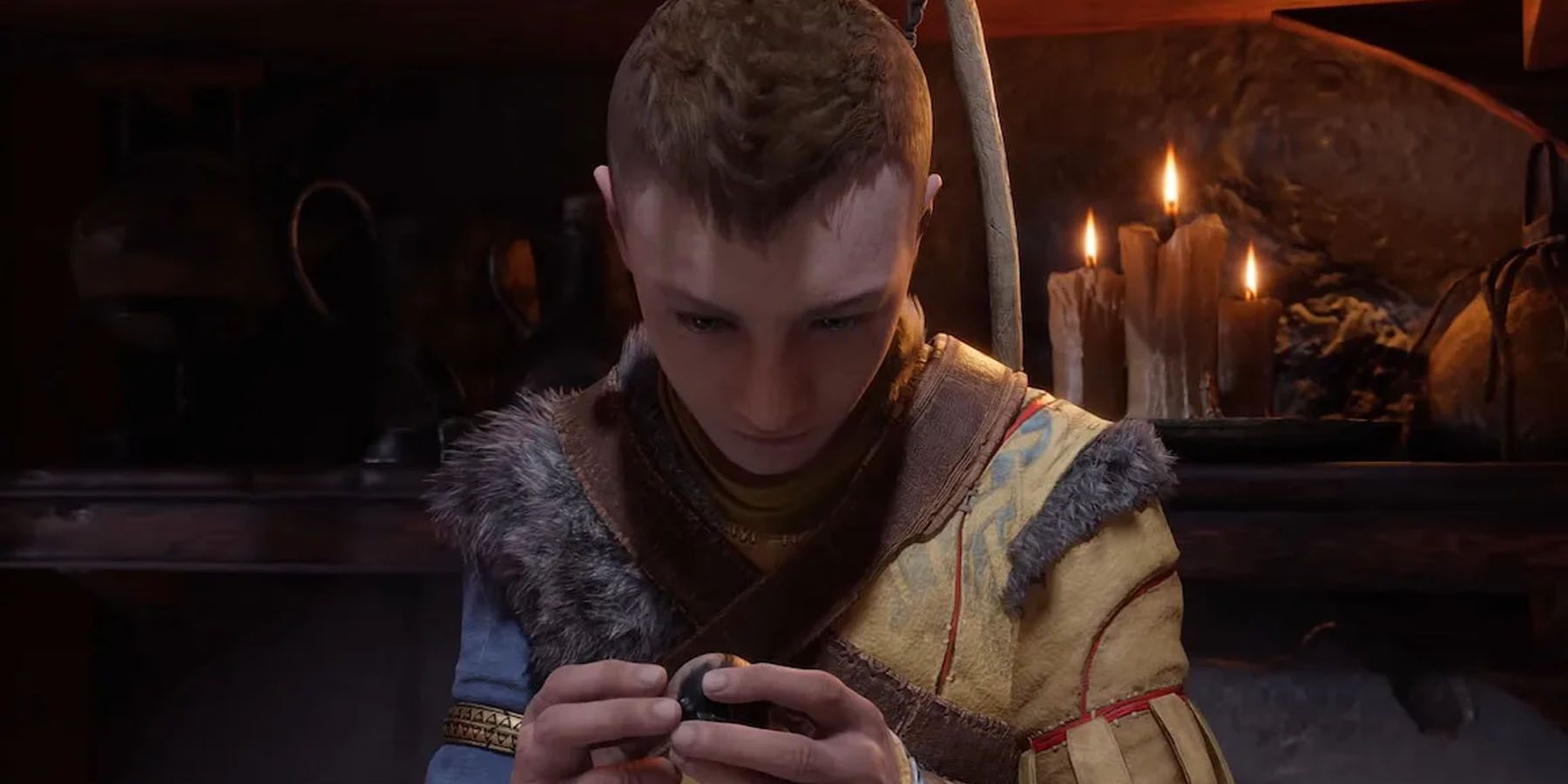A screenshot of Atreus inspecting something in Kratos's cabin in God of War Ragnarok.
