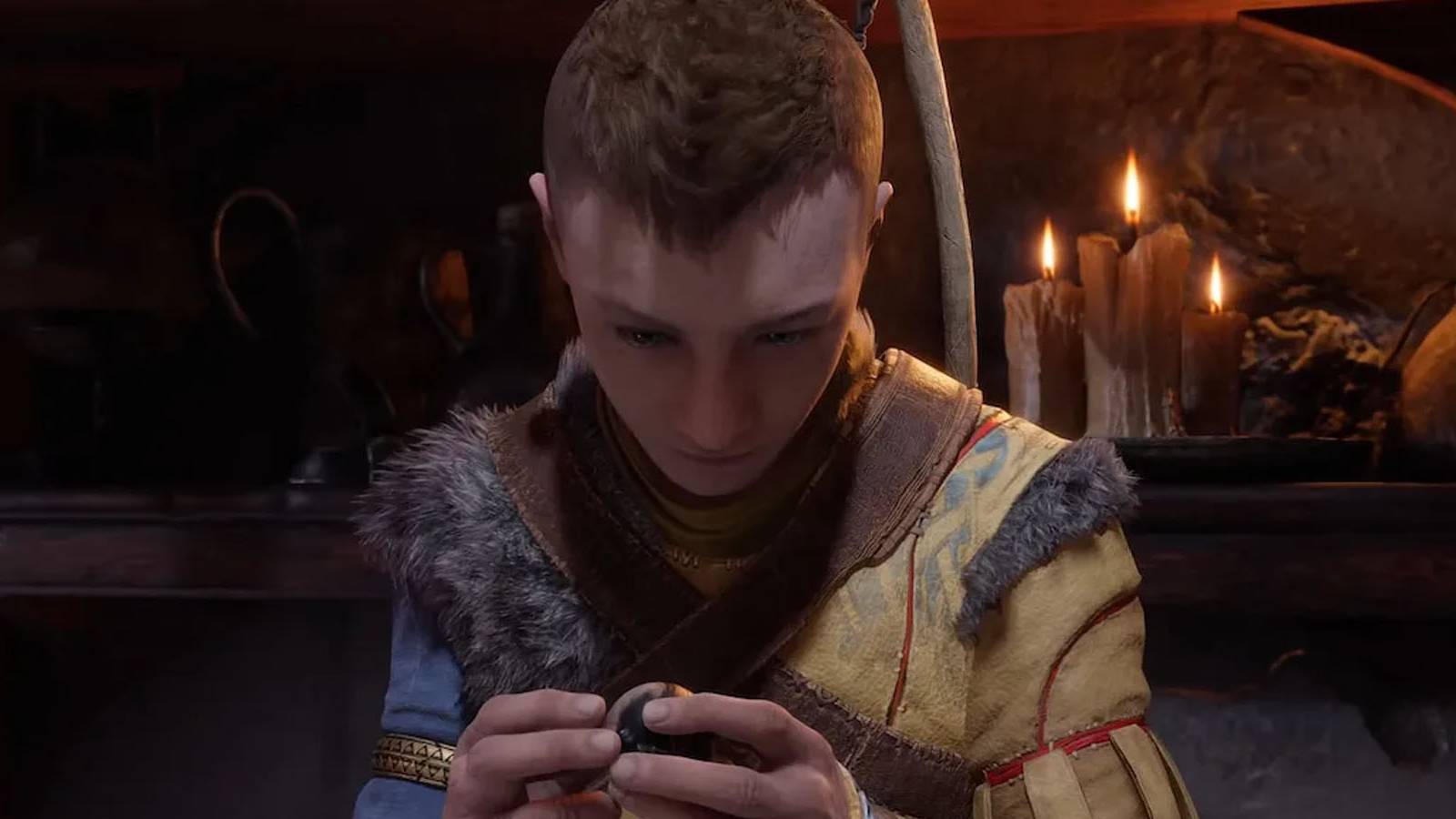 A screenshot of Atreus inspecting something in Kratos's cabin in God of War Ragnarok.