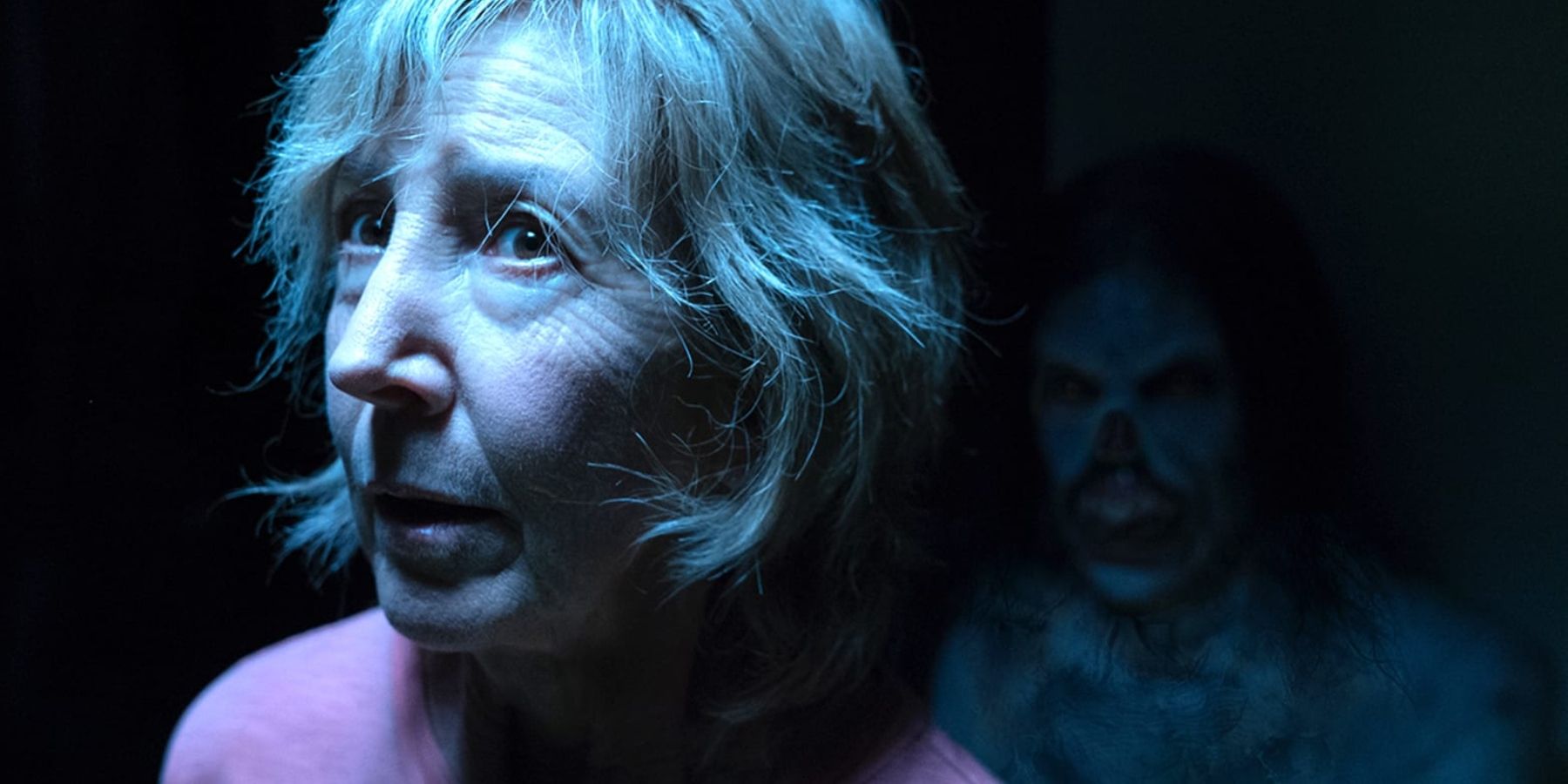 Elise Rainer in Insidious with a demon behind her