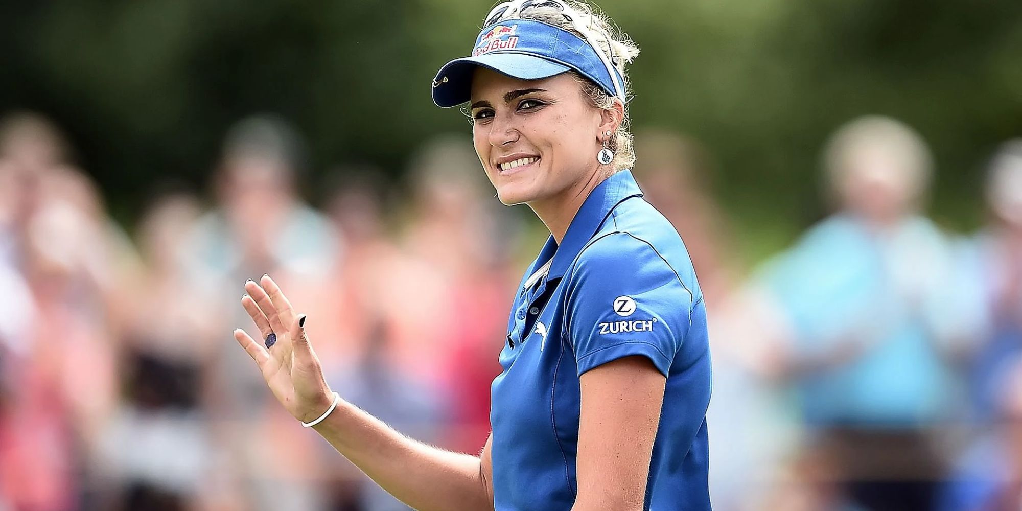 LPGA Golfer Lexi Thompson smiling and waving to the audience during a competition