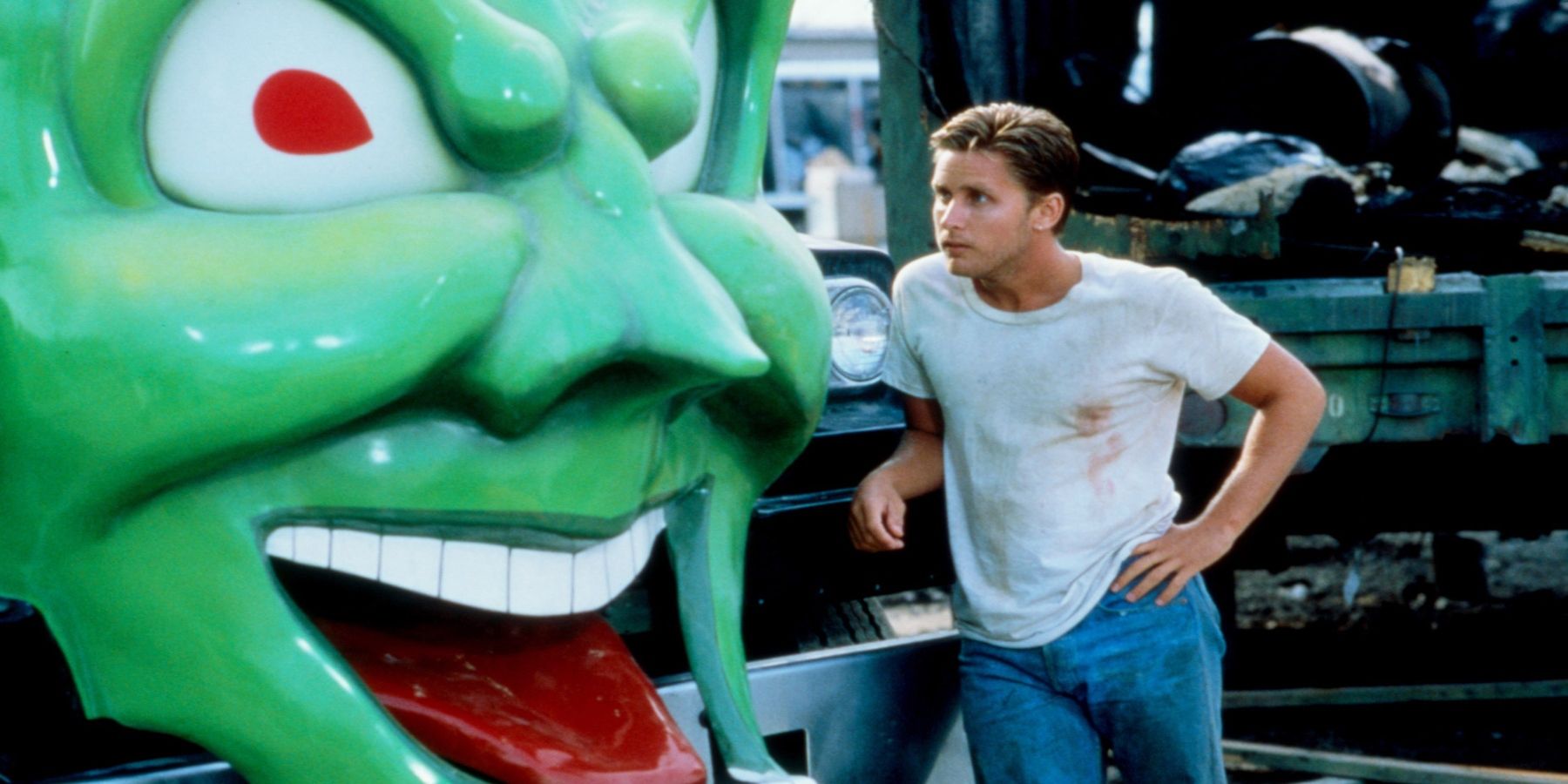 Emilio Estevez next to a car with a green face in Maximum Overdrive