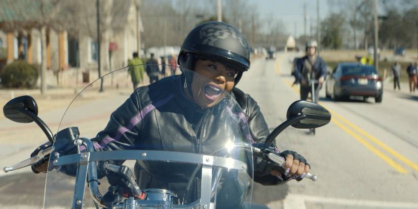 Principal Pat on the motorbike in The Big Door Prize