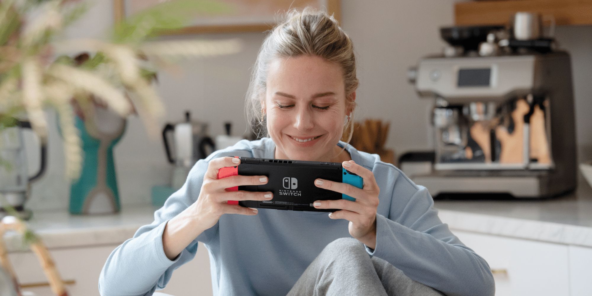 Brie Larson smiling playing Switch