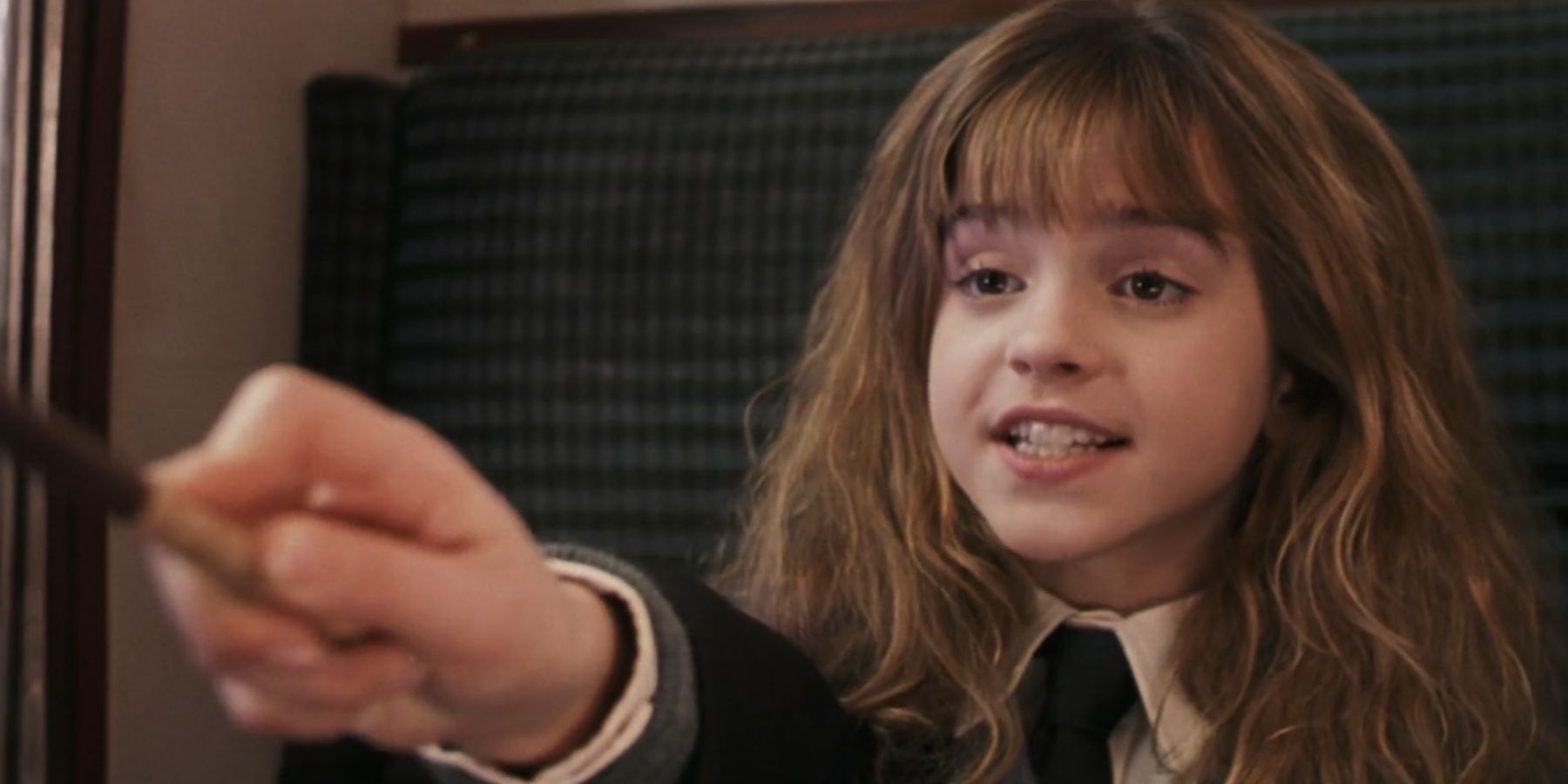 Hermione Granger using her wand in Harry Potter.