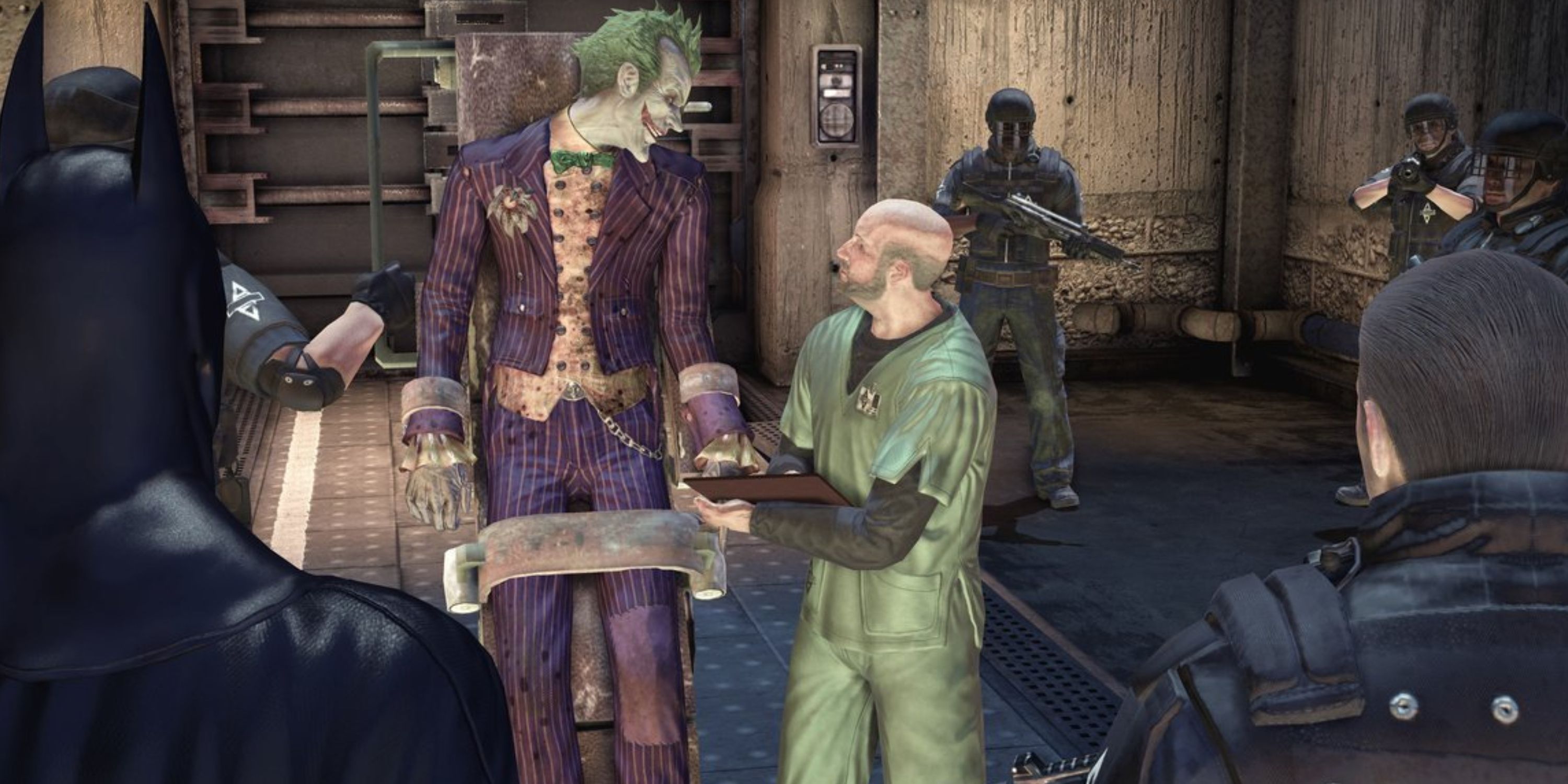 Joker strapped talking to Arkham Asylum worker as Batman and watches