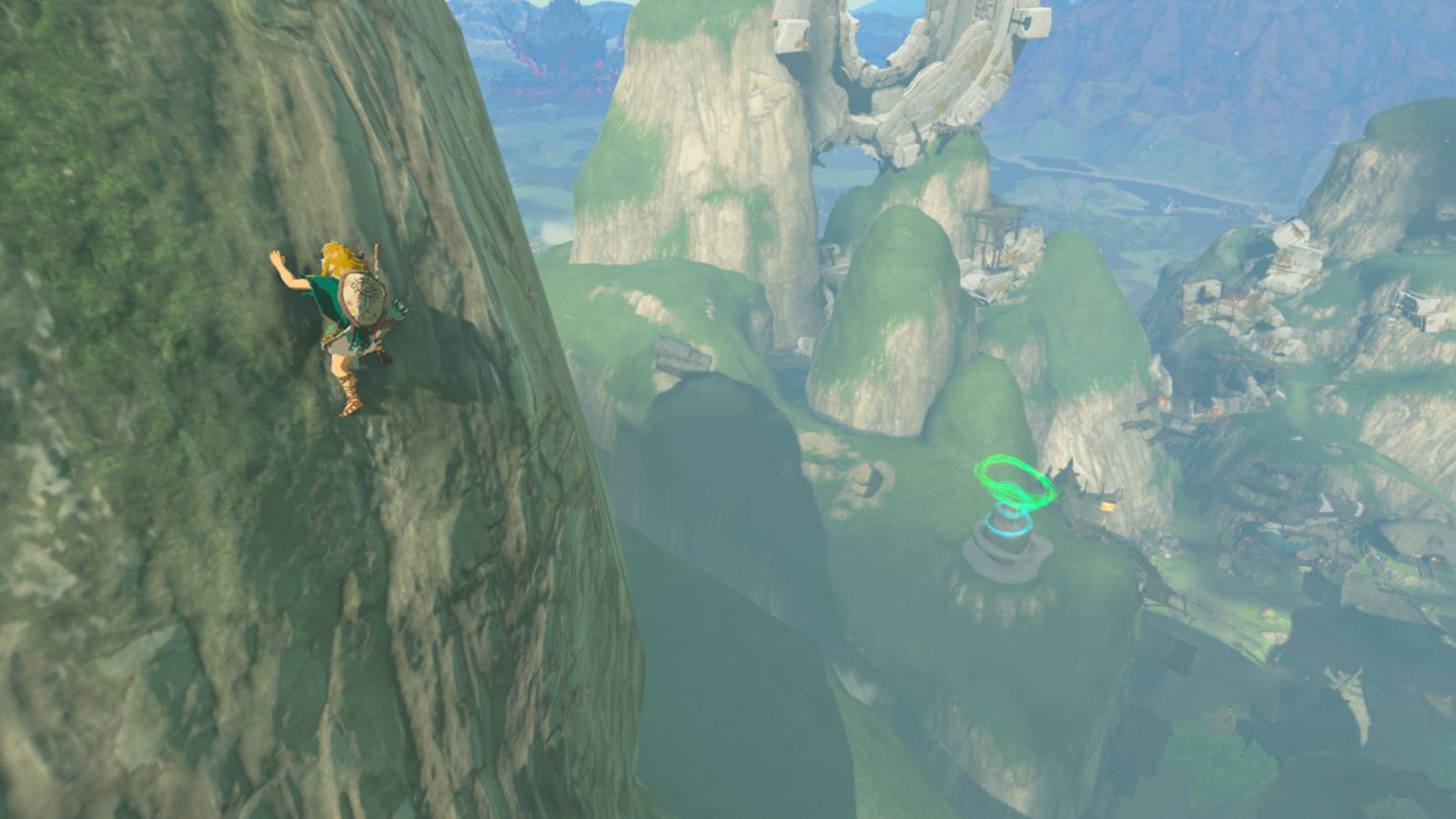 Link climbs a mountain in Tears of the Kingdom and in the background is a Shrine near Kakariko Village