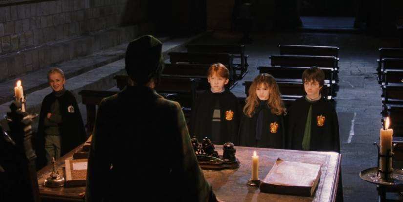 Minerva McGonagall talking to Draco Malfoy, Ron Weasley, Hermione Granger, and Harry Potter in Harry Potter.